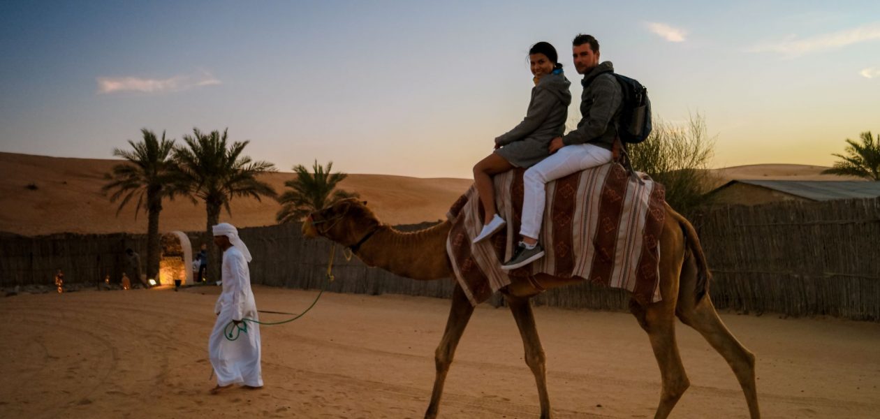 Dubai desert Safari ride on camel at dusk